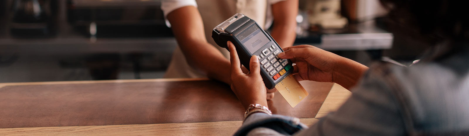 Close up of a person's hand using a credit card