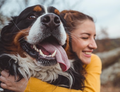 a young woman hugging a large dog